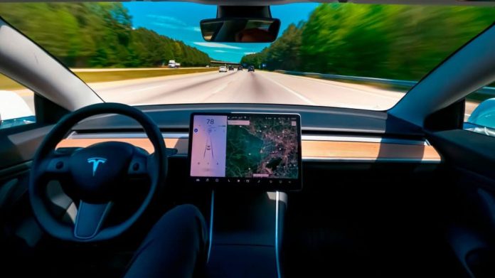 Motorista sem segurar no volante em Tesla no piloto automático